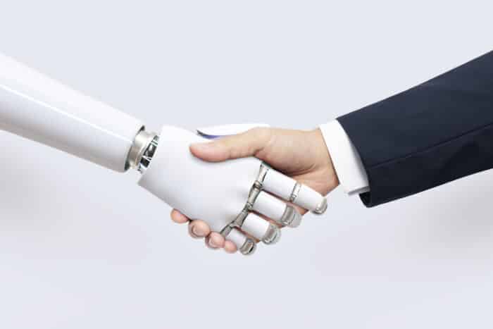 Man shaking hands with robot 