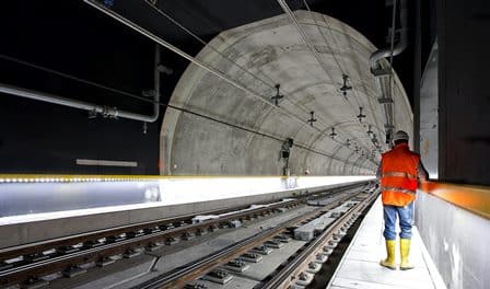 A civil engineer viewing railway tracks in a tunnel