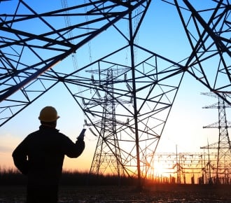 male shadow with electrical wiring in background with sunset