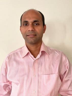 teaching award winner - Deepak Pais in pink shirt